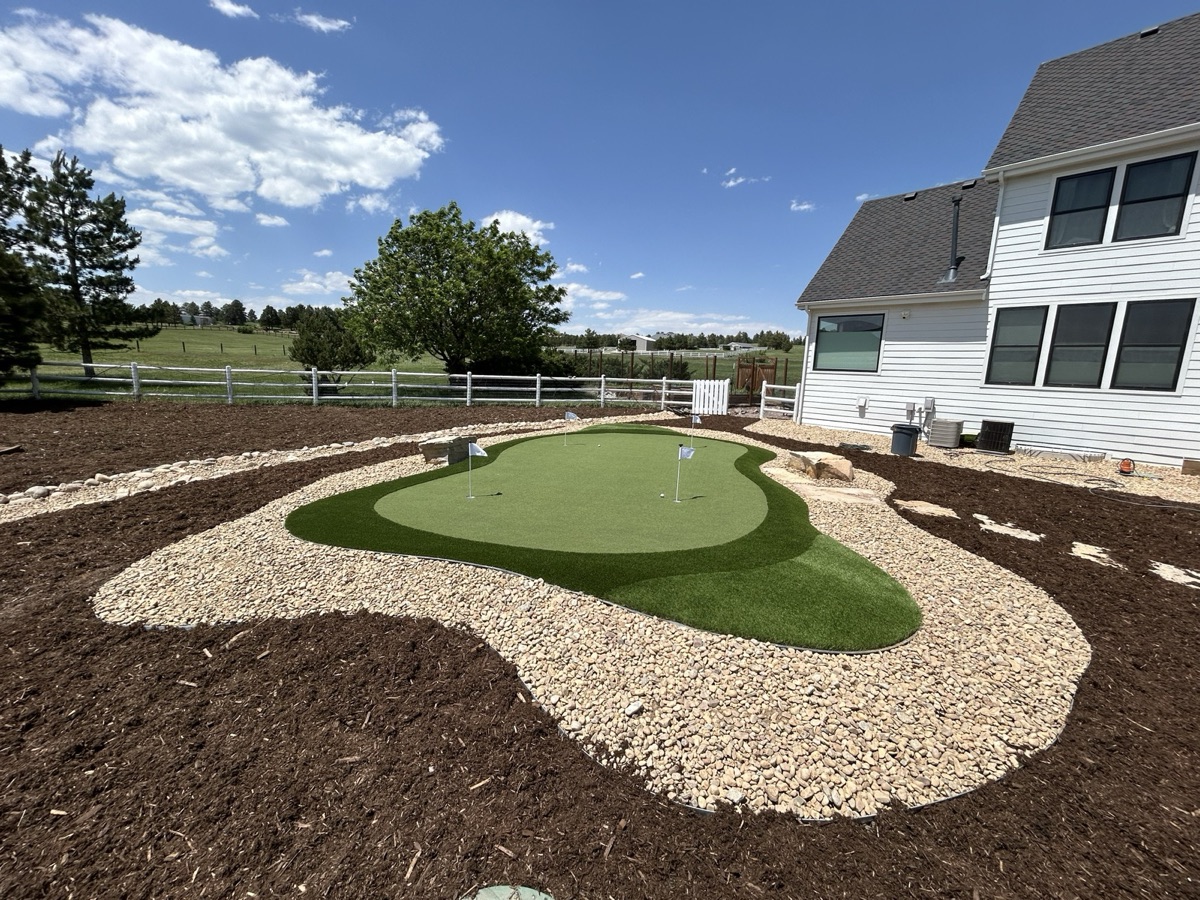 Custom putting green with landscaping in Denver backyard