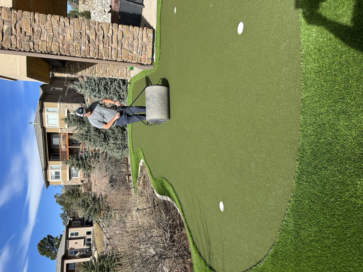 Commercial brush machine in use on a putting green